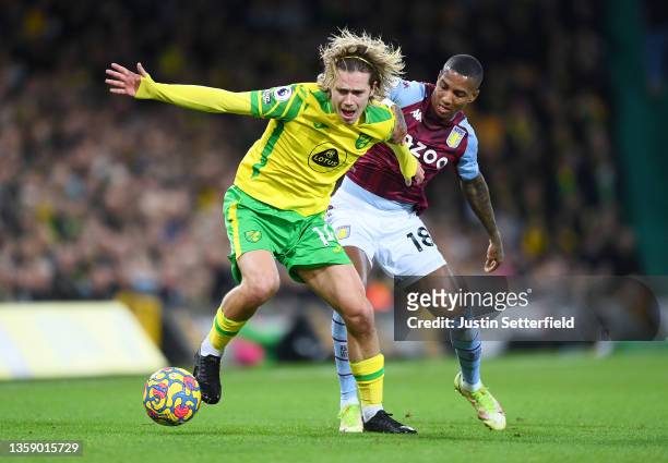 Todd Cantwell of Norwich City battles for possession with Ashley Young of Aston Villa during the Premier League match between Norwich City and Aston...