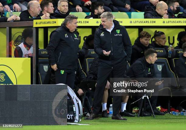 Dean Smith, Manager of Norwich City speaks with Craig Shakespeare, Assistant Head Coach of Norwich City during the Premier League match between...