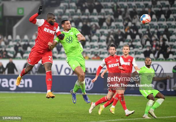 Anthony Modeste of 1.FC Koeln scores their side's third goal whilst under pressure from Maxence Lacroix of VfL Wolfsburg during the Bundesliga match...