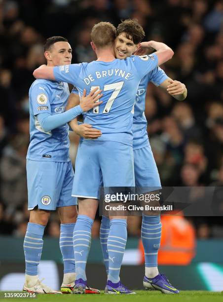 Kevin De Bruyne of Manchester City celebrates after scoring their side's fifth goal with Phil Foden and John Stones during the Premier League match...
