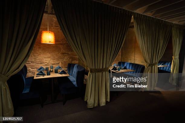 an elegant restaurant with intimate curtained booths. - speakeasy stock pictures, royalty-free photos & images