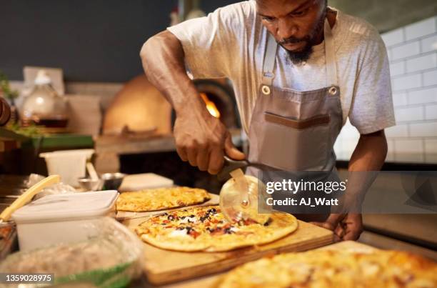 chef preparing pizza at pizzeria - pizzeria stockfoto's en -beelden