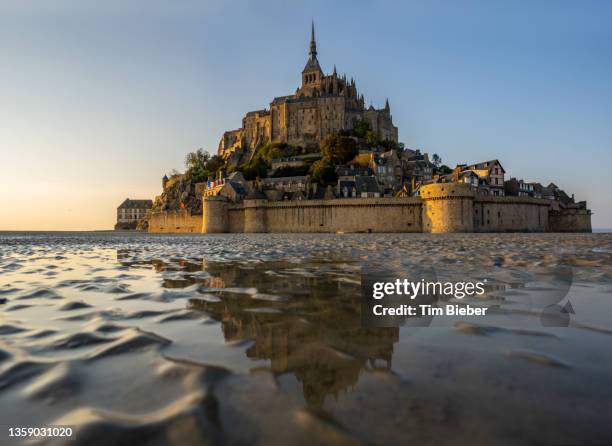 looking across the tidal water at the majestic abby of le mont-saint-michel - nun isolated stock pictures, royalty-free photos & images