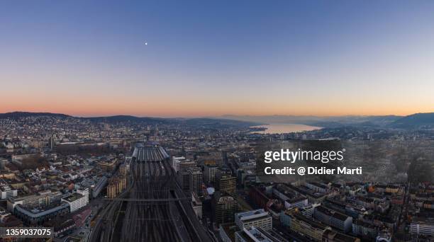 aerial panoramic view of the sunset over zurich main train station and city - lake zurich switzerland stock pictures, royalty-free photos & images