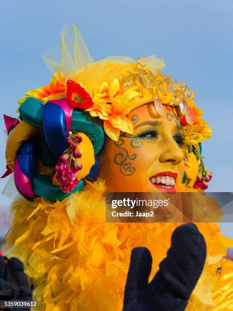 woman dressed in yellow costume, walking along in the maastricht carnaval parade - carnaval limburg stock pictures, royalty-free photos & images