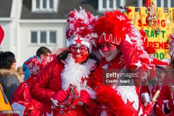 two cheerful women walking along in a dutch carnaval parade (2013) - carnaval limburg stock pictures, royalty-free photos & images