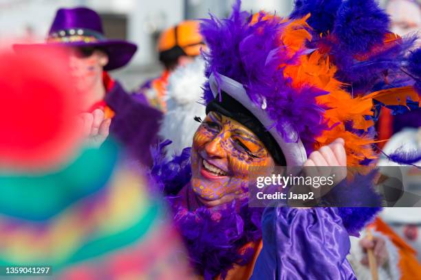cheerful woman walking along in a dutch carnaval parade (2013) - carnaval limburg stock pictures, royalty-free photos & images