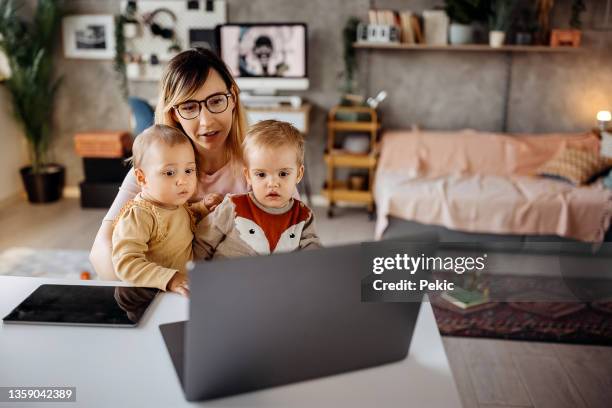 watching cartoon with her cute little kids - school life balance stock pictures, royalty-free photos & images