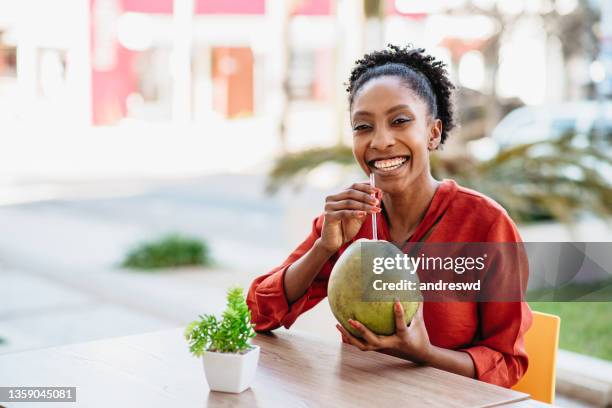 woman drinking coconut water in summer. - coconut water stock pictures, royalty-free photos & images