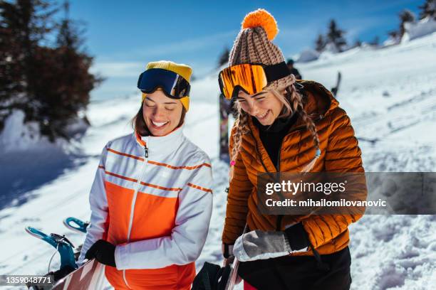 loving the mountains since they were kids - snowboard imagens e fotografias de stock