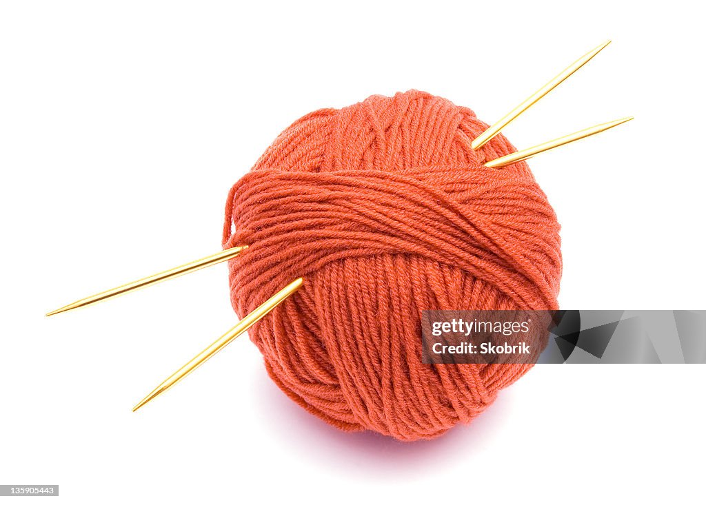 Red ball of wool and knitting needles