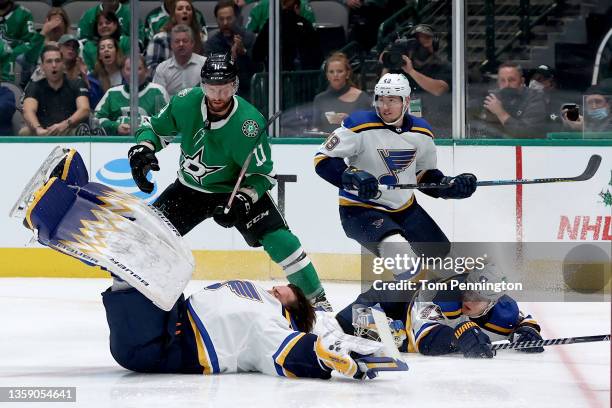 Charlie Lindgren of the St. Louis Blues get tripped up by Torey Krug of the St. Louis Blues on a play against Luke Glendening of the Dallas Stars in...