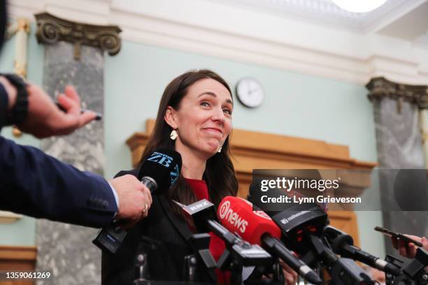 New Zealand Prime Minister Jacinda Ardern smiles while talking with press gallery reporters before the last question time of the year on December 15,...