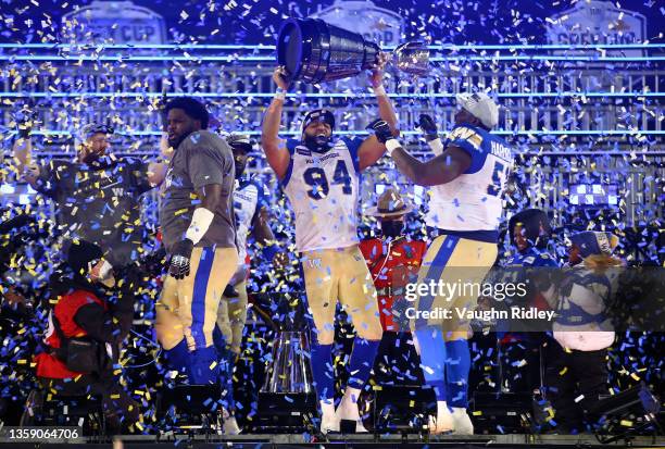 Jackson Jeffcoat and Jermarcus Hardrick of the Winnipeg Blue Bombers celebrate victory with the Grey Cup following the 108th Grey Cup CFL...