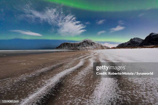 frozen beach under northern lights in winter, norway - lofoten en vesterålen stockfoto's en -beelden