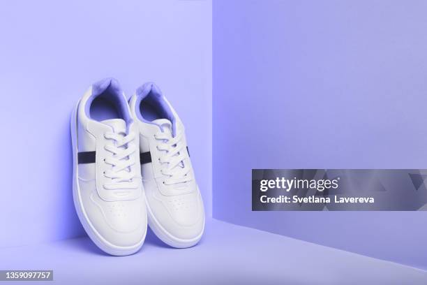 white sport sneakers shoes on the violet background. fitness background. - his shoes stock-fotos und bilder