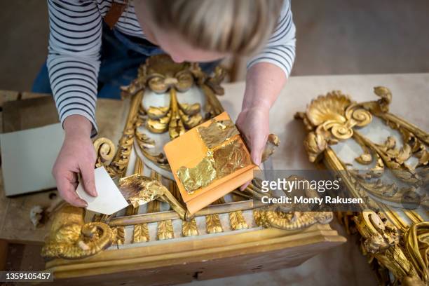 uk, darlington, woman gilding 18th century chippendale wall brackets - gold leaf stock pictures, royalty-free photos & images