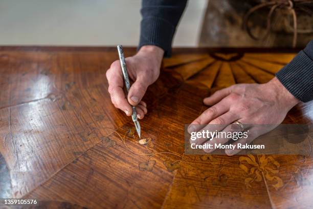 uk, darlington, hands of restorer working on marquetry side table - marquetry stockfoto's en -beelden