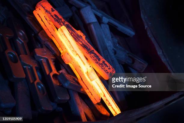 red hot newly forged straps (mining components) cooling down - cooling down stock-fotos und bilder