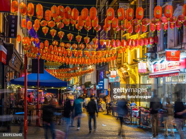 london chinatown busy streets and restaurants beneath chinese lanterns night - chinatown stock pictures, royalty-free photos & images