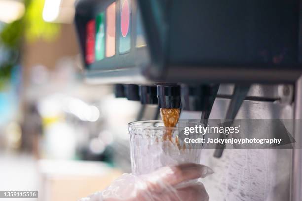 man pours a fizzy drink.sparkling water.cool ice soft drink cola - change dispenser stock pictures, royalty-free photos & images