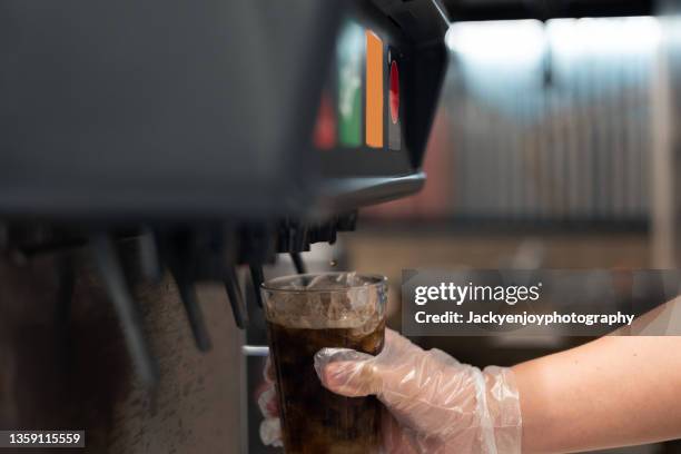 man pours a fizzy drink.sparkling water.cool ice soft drink cola - seifenspender stock-fotos und bilder