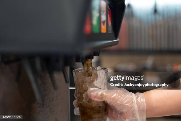 man pours a fizzy drink.sparkling water.cool ice soft drink cola - tape dispenser stock-fotos und bilder