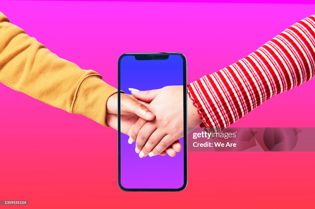Couple holding hands on smartphone