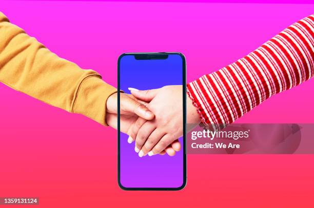 couple holding hands on smartphone - tinder stock pictures, royalty-free photos & images