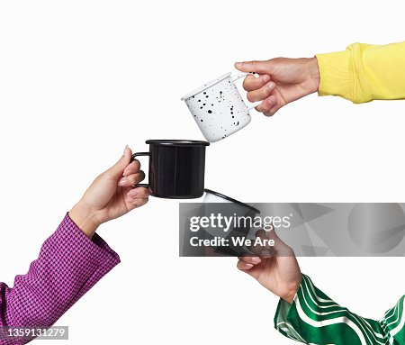 Three people toasting with mugs Three people toasting with mugs