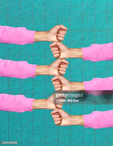 clenched hands stacked one on top of another - resilience stock pictures, royalty-free photos & images