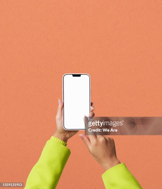 conceptual image of man using smartphone to view bar graph - hand stock-fotos und bilder