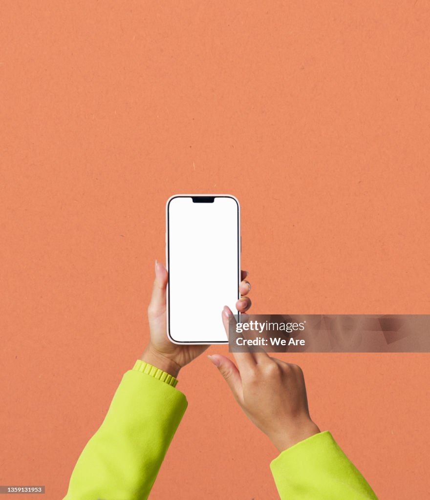 Conceptual image of man using smartphone to view bar graph