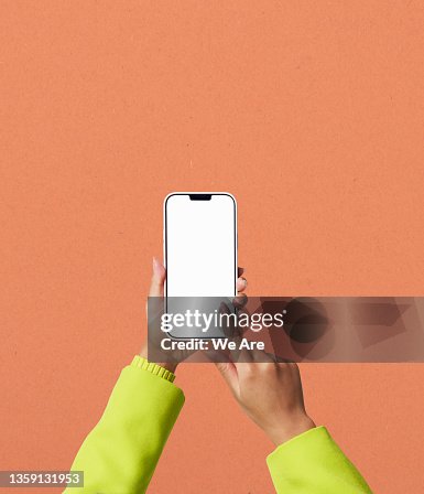 Conceptual image of man using smartphone to view bar graph Conceptual image of man using smartphone to view bar graph