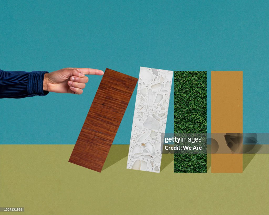 Hand pushing over columns on a bar graph