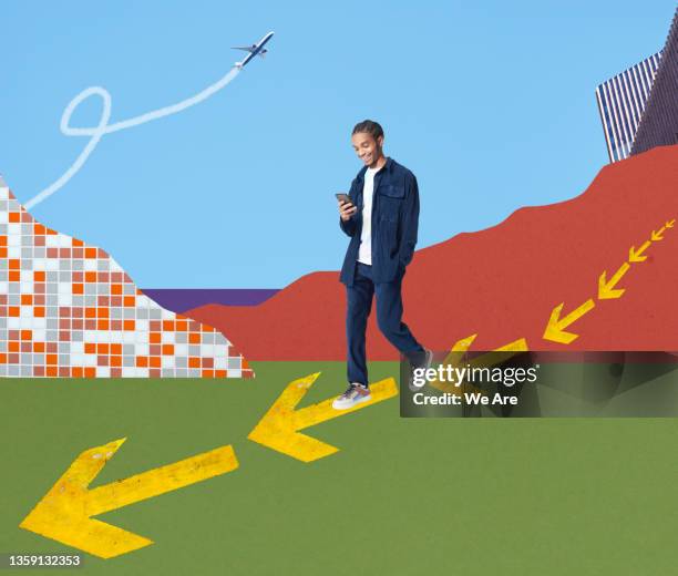 young fashionable man walking on arrows using smartphone - following arrows stock pictures, royalty-free photos & images