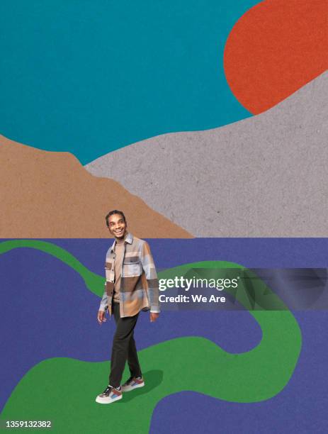 young businessperson walking through conceptual landscape - neue wege gehen stock-fotos und bilder