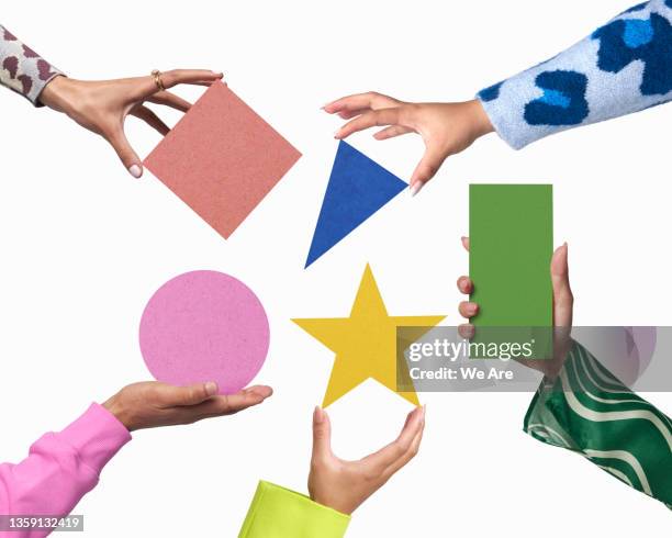 hands holding geometric shapes - neurodiversidad fotografías e imágenes de stock