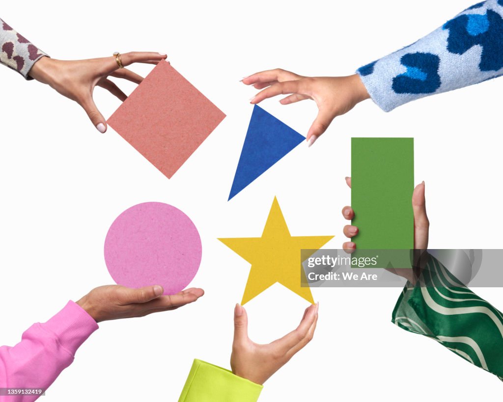 Hands holding geometric shapes