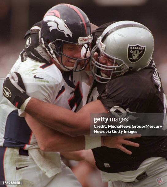 Raiders DT Kevin Johnson hauls down Broncos QB John Elway after he released a pass in the fourth quarter. The Raiders defeated the previously...