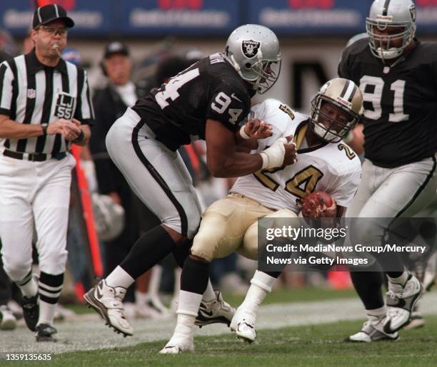 Raider DE Anthony Smith pulls down Saints running back Mario Bates by his jersey in the first quarter. Smith threw Bates out of bounds and was called...