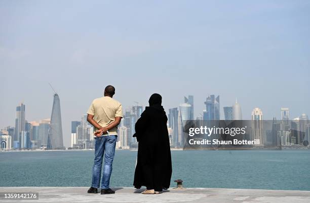 People look at the downtown skyline from the Corniche during the FIFA Arab Cup Qatar on December 15, 2021 in Doha, Qatar.