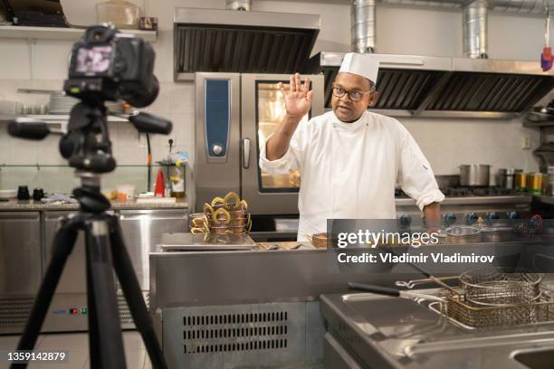 a professional chef waving to the camera - virtual lunch stock pictures, royalty-free photos & images