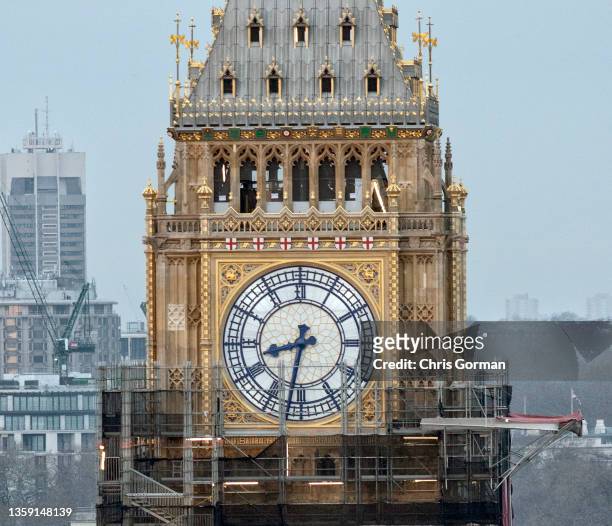 The clock face is shown as scaffolding is starting to be removed from Elizabeth Tower on December 14,2021 in London, England. Big Ben is the nickname...