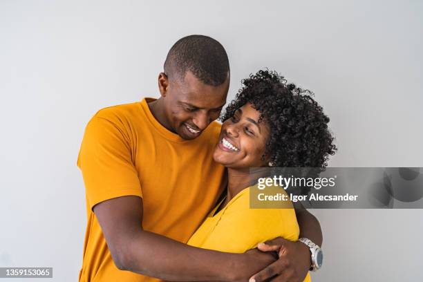 portrait of a happy couple embracing - blusa cor de laranja imagens e fotografias de stock