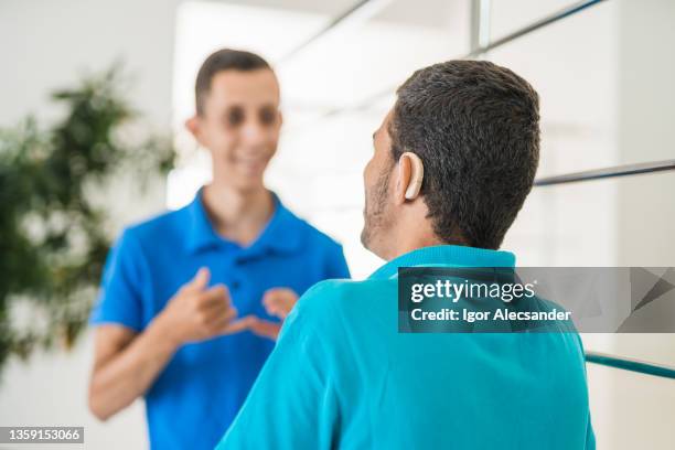 rear view of a hearing impaired person - sign language interpreter medical stock pictures, royalty-free photos & images