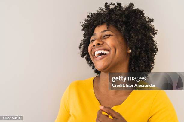 portrait of a young woman laughing - satisfaction face stock pictures, royalty-free photos & images