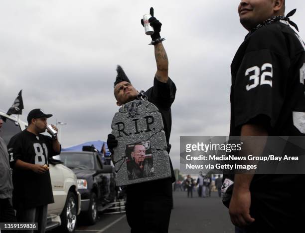 Oakland Raiders fan Hugo Gonzalez, from Pleasant Hill, poses for a photograph with his homemade headstone dedicated to Raiders Owner Al Davis before...