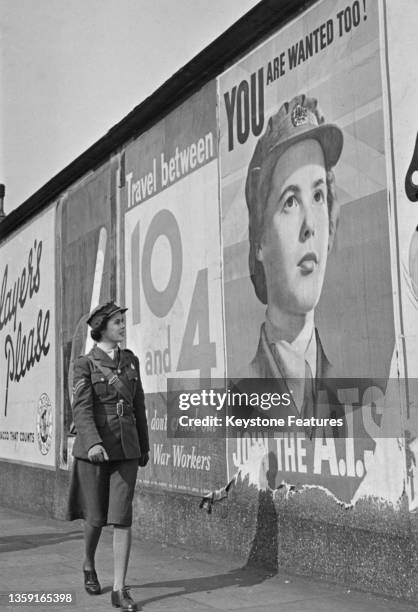 Corporal Mary Catherine Roberts looks at the image of herself on the official recruitment poster for the Auxiliary Territorial Services on 2nd April...