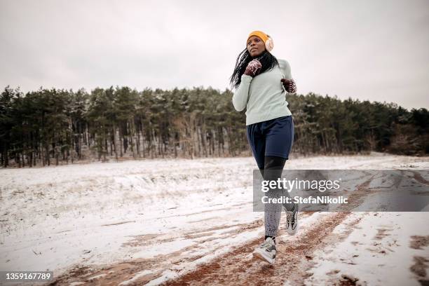 fitness running woman in winter season - winter jogging stock pictures, royalty-free photos & images